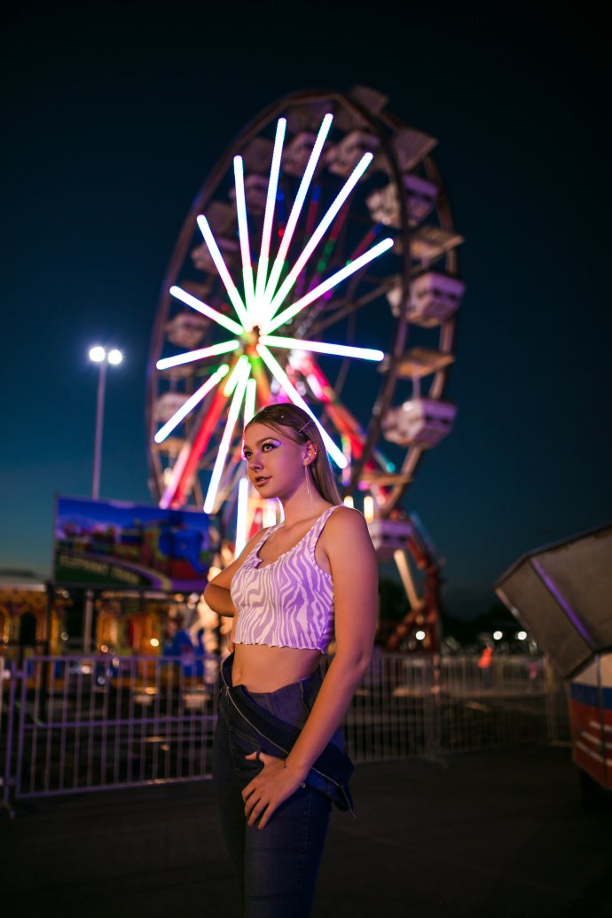Portrait photographer in Vanderbijlpark, S Brazier Photography. Photo of a girl standing in front of a ferris wheel.
